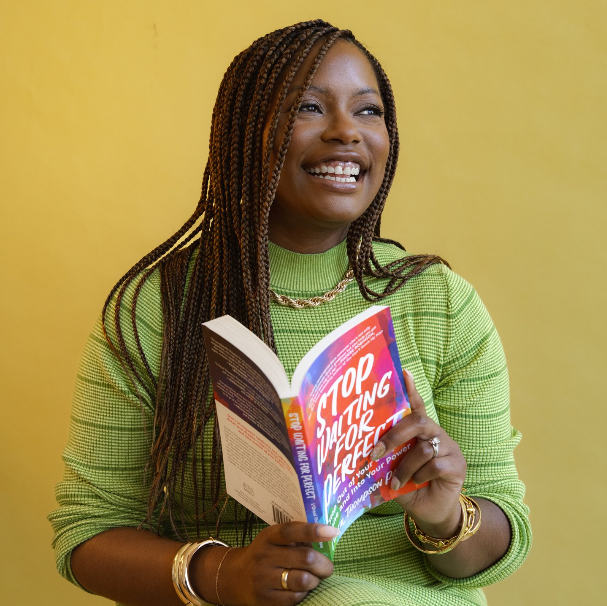 L’Oreal Thompson Payton holding her book, Stop Waiting for Perfect
