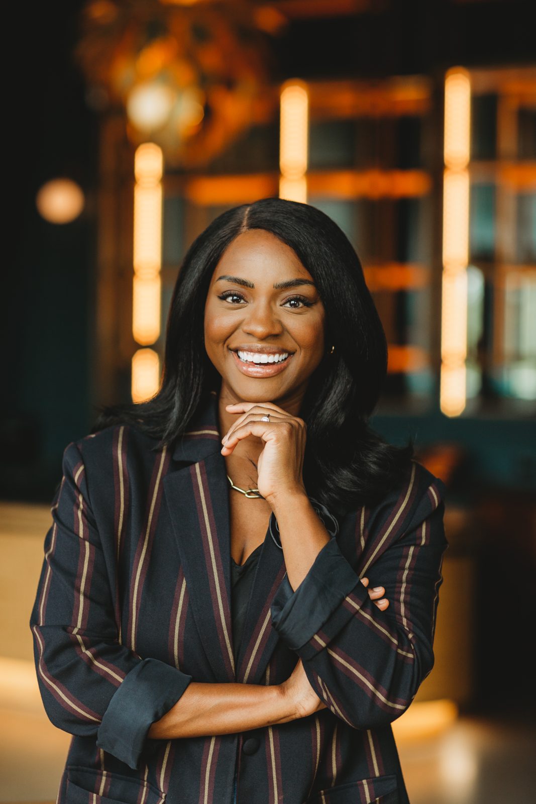 Danielle Bayard Jackson smiling in a striped blazer